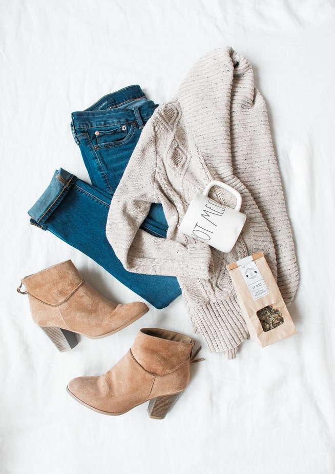 blue jeans, beige sweater and light brown suede boots laid out for evening routine