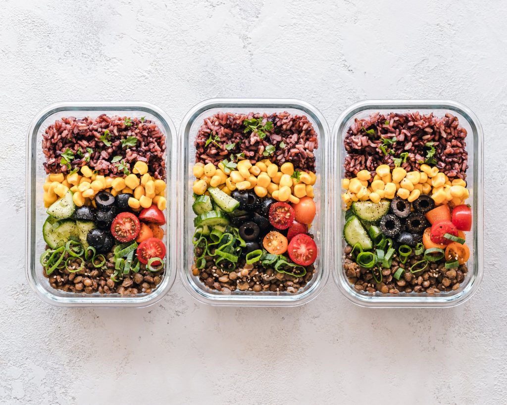 Three identical salads in resealable lunch containers for meal prep for evening routine