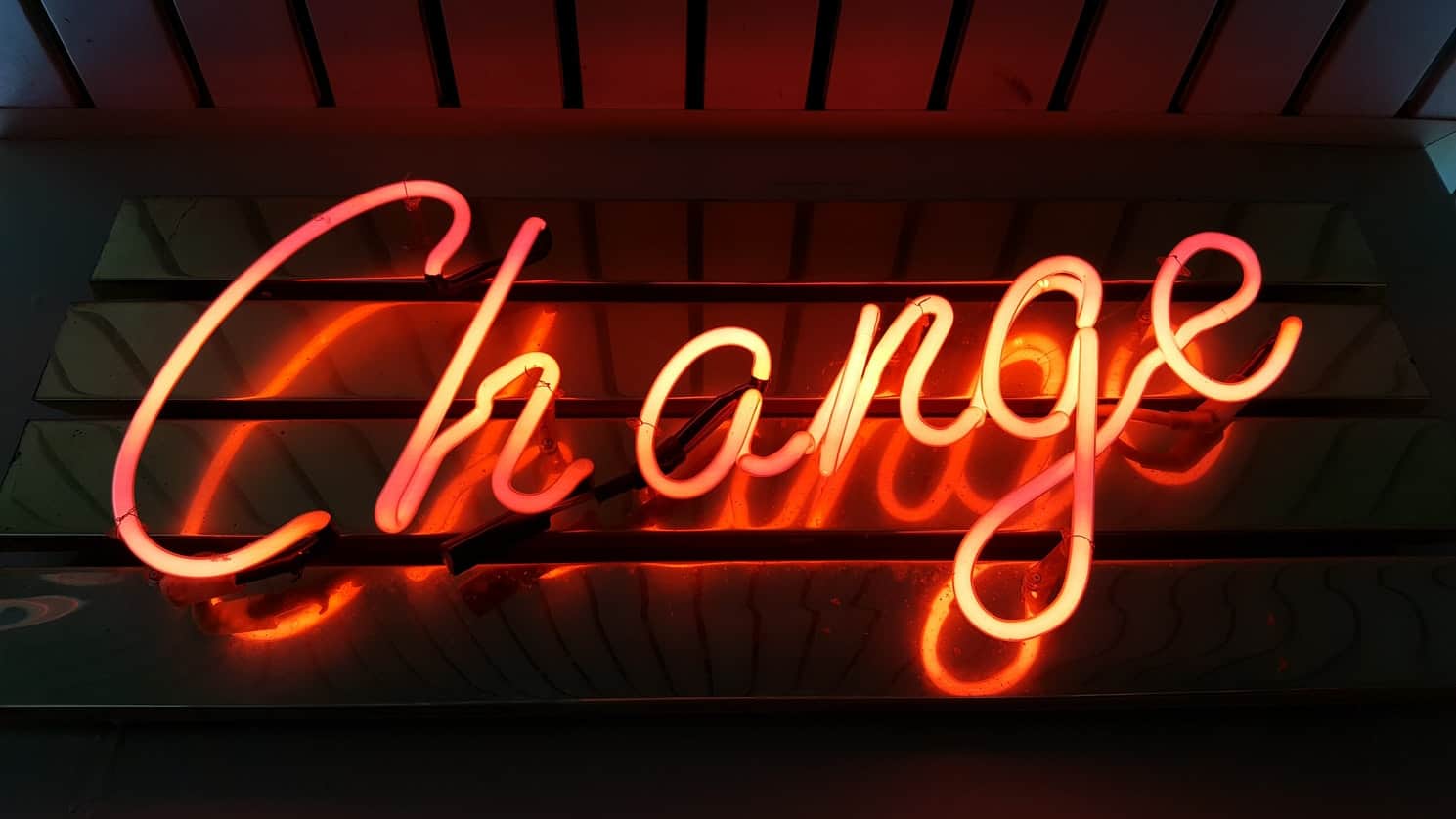 Neon sign says change. All goals are changeable.