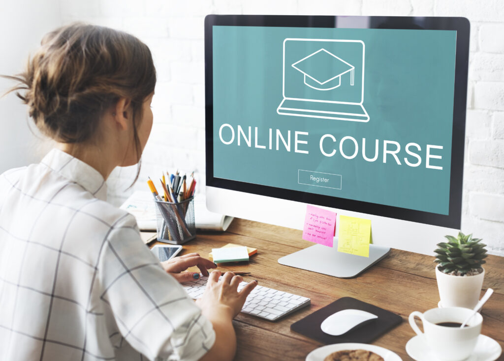 How to Increase Your Income by creating an online course, woman at computer creating an online course