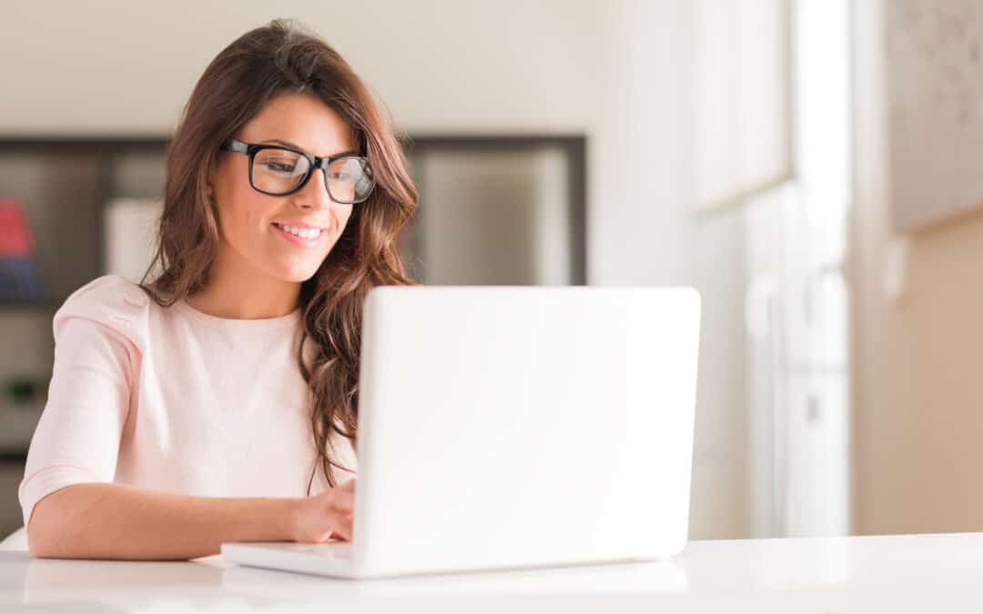 Make Extra Money Online. Woman sitting at computer writing.