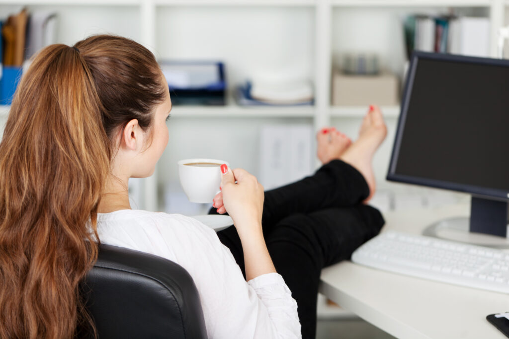 Stay at Home Jobs woman sitting drinking coffee with feet up on desk
